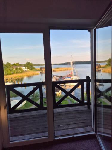 a view of a river with a boat in the water at Pensjonat Rybaczówka - noclegi, restauracja, port in Giżycko