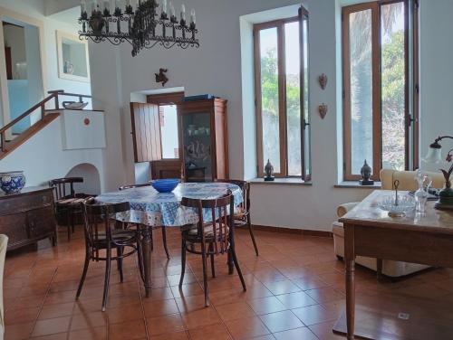 a kitchen and dining room with a table and chairs at Villa MariaRosa in Lipari