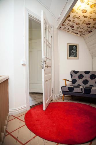 a living room with a red rug and a couch at Boråkra Bed & Breakfast in Karlskrona
