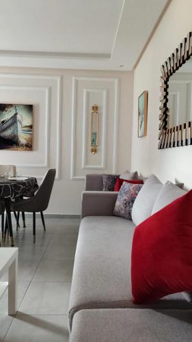 a living room with a couch and a table at Appartement costamar à 200m de la plage in Martil