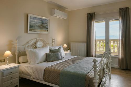 a bedroom with a bed and a large window at Villa Sunset in Argostoli