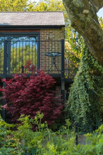 a gazebo in a garden with colorful plants at Waterfield House B&B in Dorchester