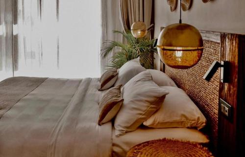 a bedroom with a bed with pillows and a window at Le Sidi Cabana Near Marassi in El Alamein