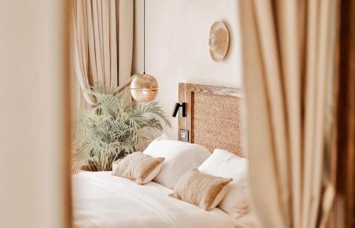 a bedroom with a bed with white sheets and pillows at Le Sidi Cabana Near Marassi in El Alamein