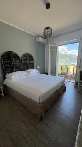a bedroom with a large bed and a balcony at Casa Carlotta Lake Como in Lezzeno