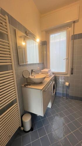 a bathroom with a sink and a mirror and a toilet at Casa Carlotta Lake Como in Lezzeno