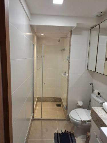 a bathroom with a shower and a toilet at Flat Vista Pedra Azul - Vista Azul Apart Hotel in Pedra Azul
