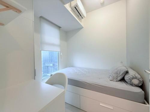 a white bedroom with a bed and a window at Anderson pakuwon 2 Bedroom 6 people stay in Surabaya
