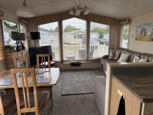 a living room with a couch and a table and chairs at Nockys nook in Filey