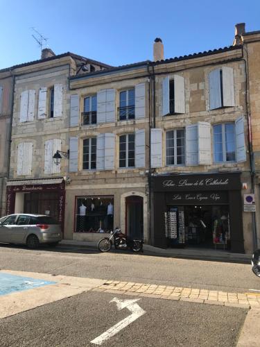 a building on a street with a car parked in front at Lectoure Retreat in Lectoure