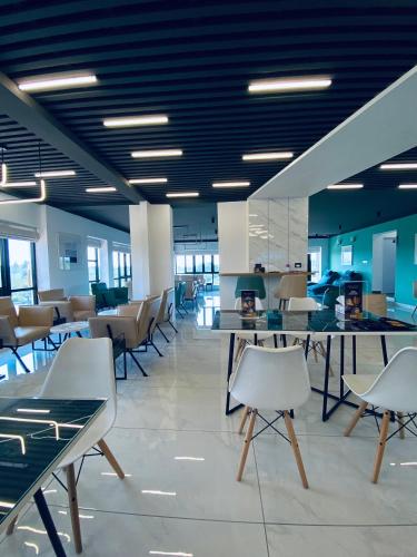 an office with tables and chairs and blue ceilings at DOZ Lounge in Krishnagiri