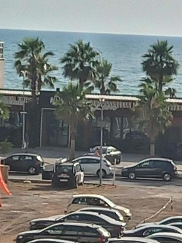 a group of cars parked in a parking lot next to the ocean at Apartament shëngjin lisuss apartments lux in Shëngjin