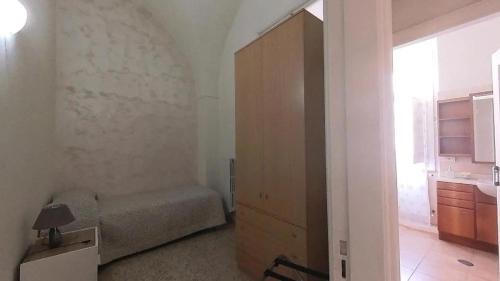 a small bedroom with a bed and a large window at Casa dei Belli - alloggio turistico in Isola del Liri