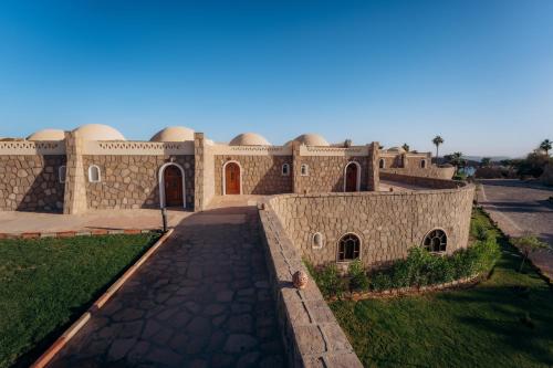 a building with domes on the side of it at Seti Abu Simbel Lake Resort in Abu Simbel