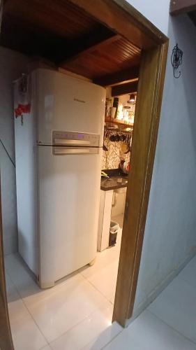 a kitchen with a white refrigerator in a room at Casa Maria in Rio Branco