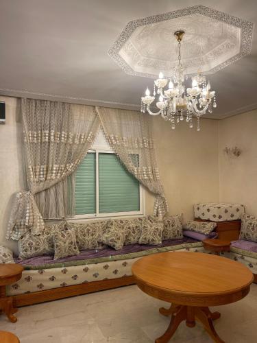 a living room with a couch and a window at coastal charm harhoura in Temara