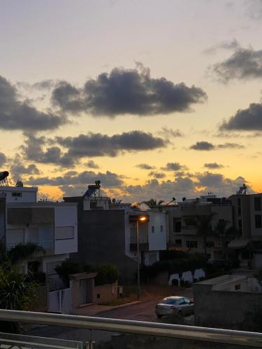 a sunset over a city with buildings and a car at coastal charm harhoura in Temara