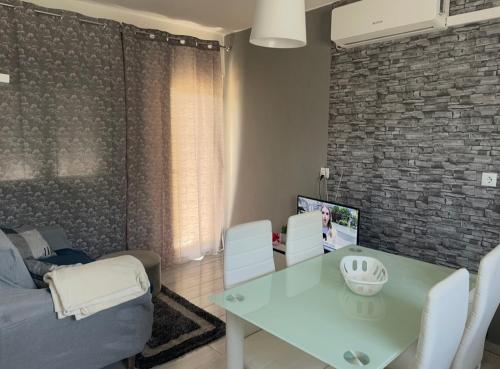 a living room with a table and a couch at Casa do Canto in Torre de Moncorvo