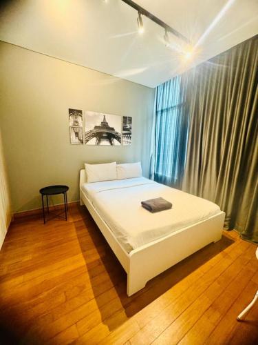 a bedroom with a white bed and a window at Sky Suites KLCC By Star Apartment in Kuala Lumpur