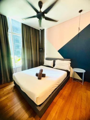 a bedroom with a bed with a teddy bear on it at Sky Suites KLCC By Star Apartment in Kuala Lumpur