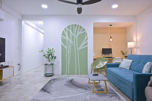 a living room with a blue couch and a surfboard on the wall at Eco-friendly house near street food quiet area in Chiang Mai