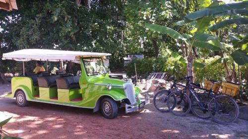a golf cart with bikes parked next to it at Belle Amie Self Catering in La Digue