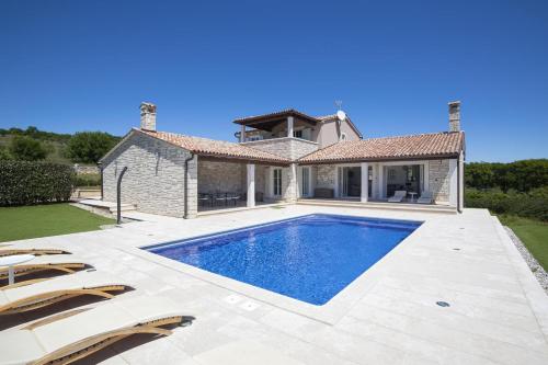 a swimming pool in the backyard of a house at Heritage Villa Lilly in Krnica