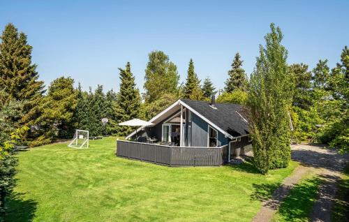 a home with a large yard with a house at Holiday Home Mælkebøttevej Væggerløse Ii in Marielyst