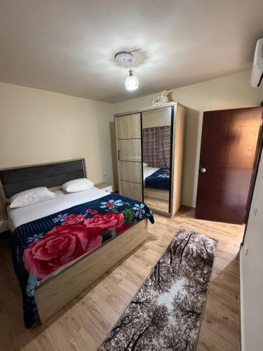 a bedroom with a bed and a large mirror at Porto Sokhna Marina Towers sea view in Ain Sokhna