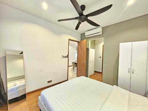 a bedroom with a bed and a ceiling fan at Sky Suites KLCC By Star Apartment in Kuala Lumpur