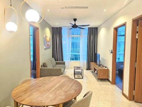 a living room with a table and a couch at Sky Suites KLCC By Star Apartment in Kuala Lumpur