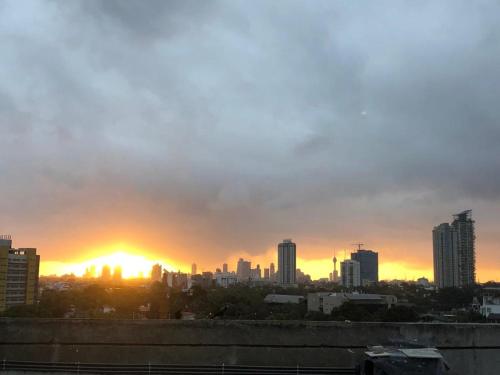 a city skyline with the sun setting in the horizon at The Luxor Roof16 in Battaramulla