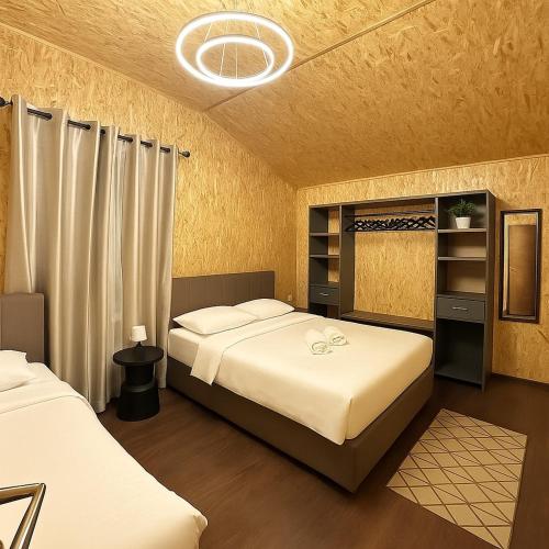 a bedroom with two beds and a closet at Vila Eilin - Cozy villa for perfect escapes in Tirana