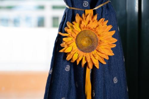 a blue dress with a yellow sunflower on it at Sina Family in Piskopianon