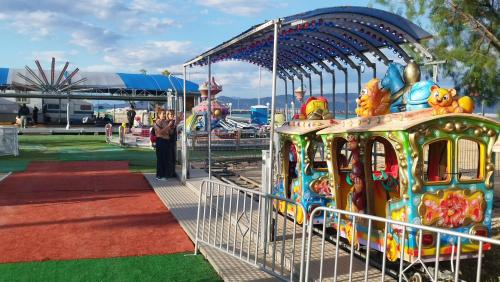 a person standing in front of a carnival ride at ΒΡΑΧΑΤΙ-Vrachati Family apartment in Vrahati
