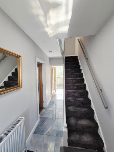 a hallway with a staircase in a house at Bellavita brand new room in Canley