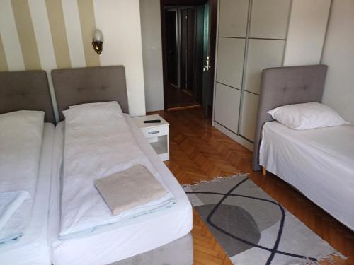 a small room with two beds and a table at Hacijenda in Bajina Bašta