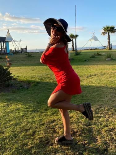 a woman wearing a red dress and a hat at Hotel Trocadero in Concón
