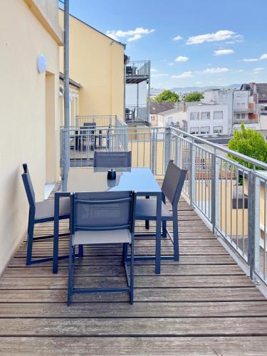 a table and chairs on the balcony of a building at Deichstadt Apartments in Neuwied