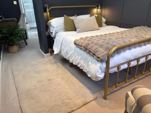 a bedroom with a bed with a gold frame at The Old Farmhouse in Bristol