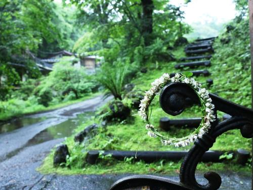 a bench with a wreath on it next to a road at Kose Onsen in Karuizawa