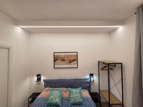 a bedroom with a bed and a white wall at Casa Amabile in Rome