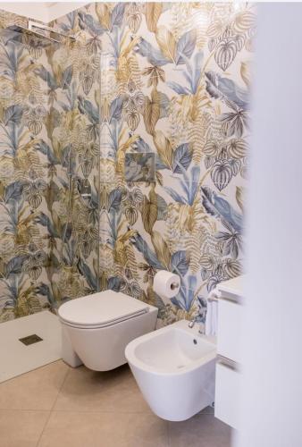 a bathroom with a toilet and a sink at B&B Terre del cretto in Nuova Gibellina