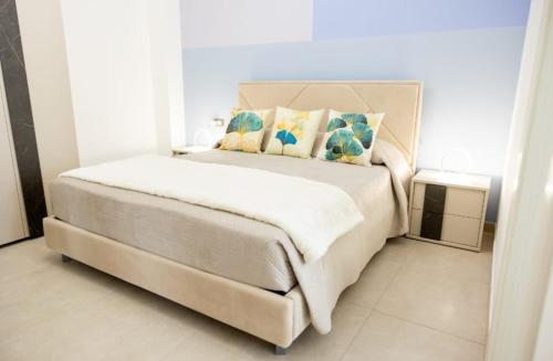 a bedroom with a white bed with pillows on it at B&B Terre del cretto in Nuova Gibellina