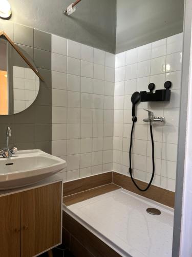 a bathroom with a shower and a sink at La Maisonnette in Nîmes