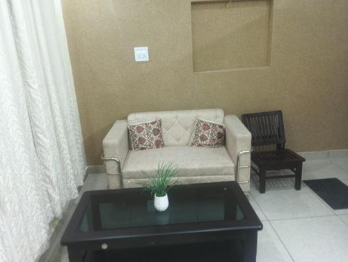 a living room with a couch and a coffee table at hill view in Pālampur
