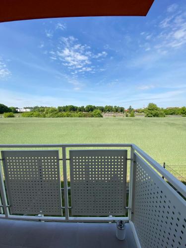 a balcony with a view of a field at Apartament Krakowska - winda, parking in Ostrów Wielkopolski
