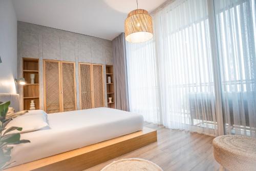 a bedroom with a bed and a large window at Palase Elite Villas in Himare