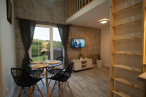 a small dining room with a table and chairs at Bunkier House in Niedźwiada