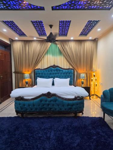 a bedroom with a blue bed and a blue rug at 818 GUEST House HOUSE 818 STREET 11 I-8 in Islamabad